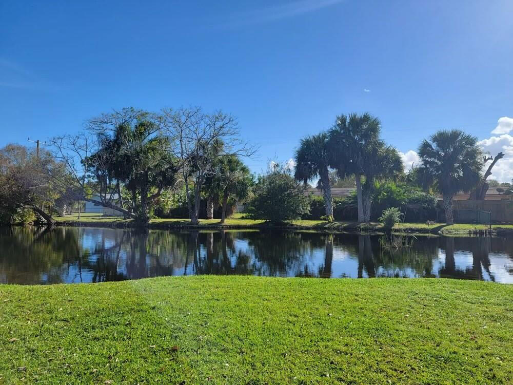2516 South 19th Street, Unit 208 Fort Pierce, FL 34982 - Photo 7 of 16 a view of a lake with a house in the background