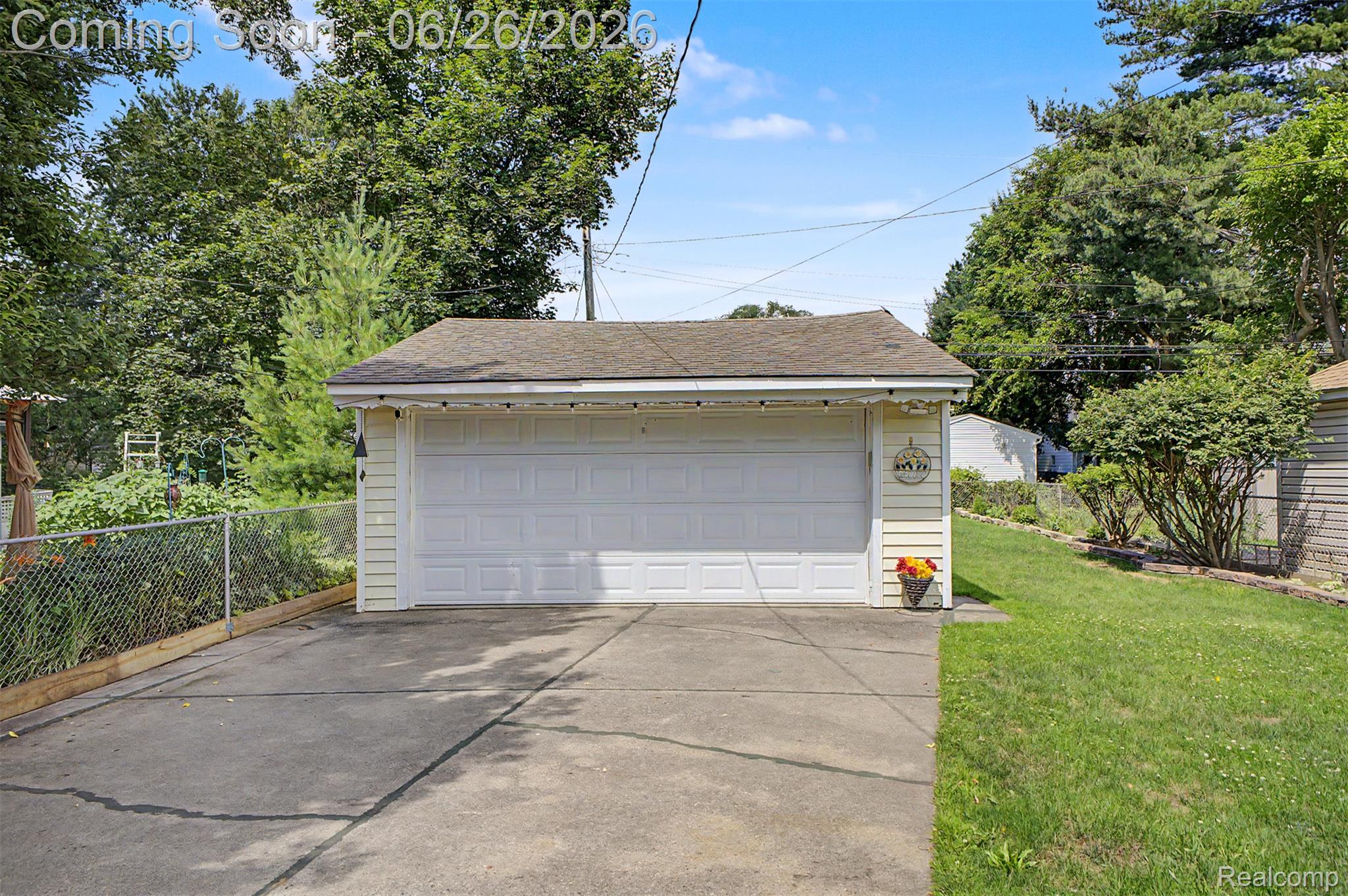2216 Banner Street Dearborn, MI 48124 - Photo 30 of 34 Detached garage featuring a white panel door, light-colored siding, and a shingle roof