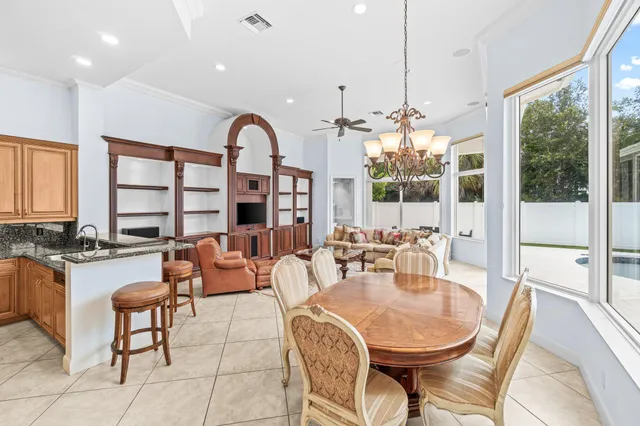 a living room with furniture fireplace and a large window