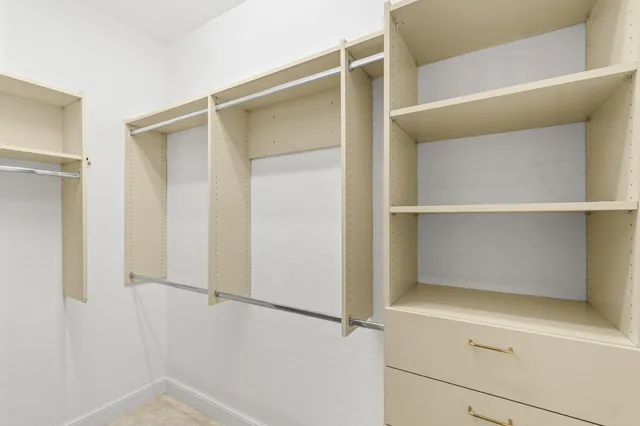 a large white bathroom with a large tub sink and mirror