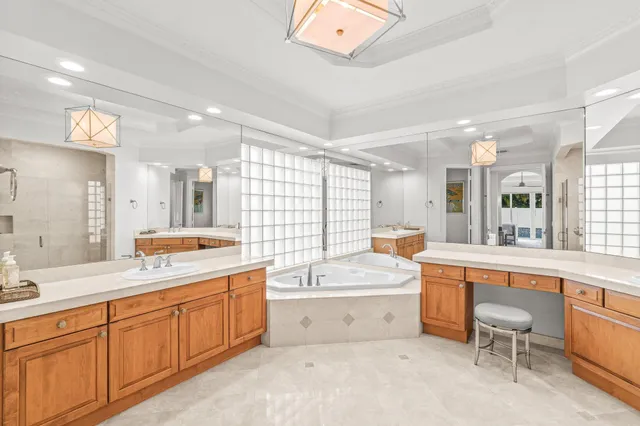 a large bathroom with a tub a sink a mirror and a shower