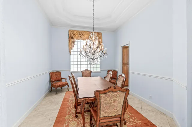 a living room with couches and a dining table with wooden floor