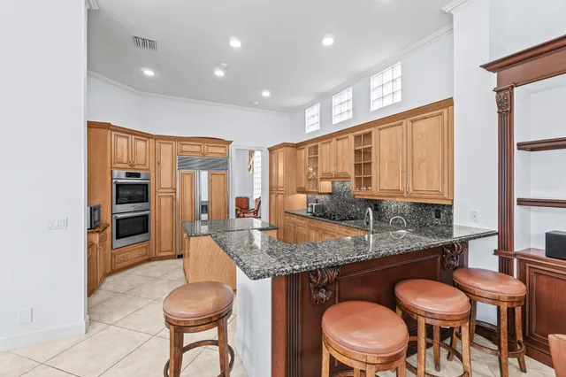 a kitchen with stainless steel appliances granite countertop a sink stove and cabinets