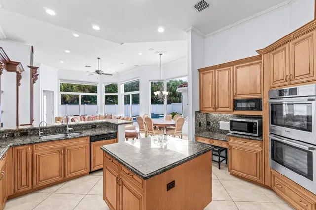 a kitchen with stainless steel appliances granite countertop a stove and a sink