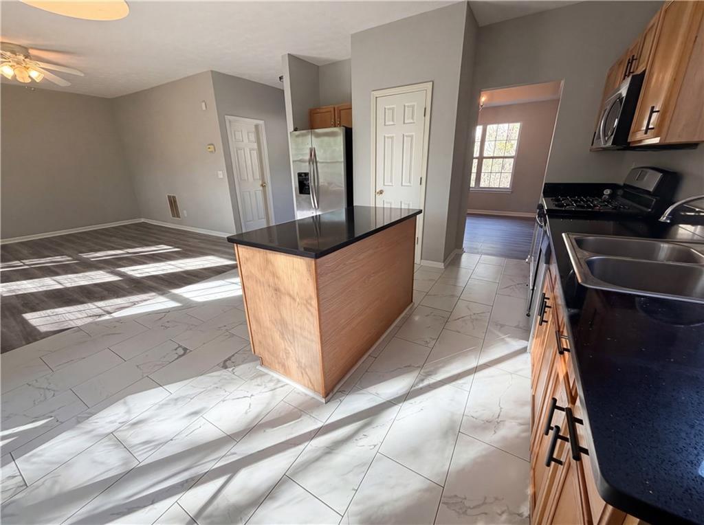 403 Clearstream Lane Austell, GA 30168 - Photo 11 of 25 a view of a kitchen with stainless steel appliances wooden floor and a window