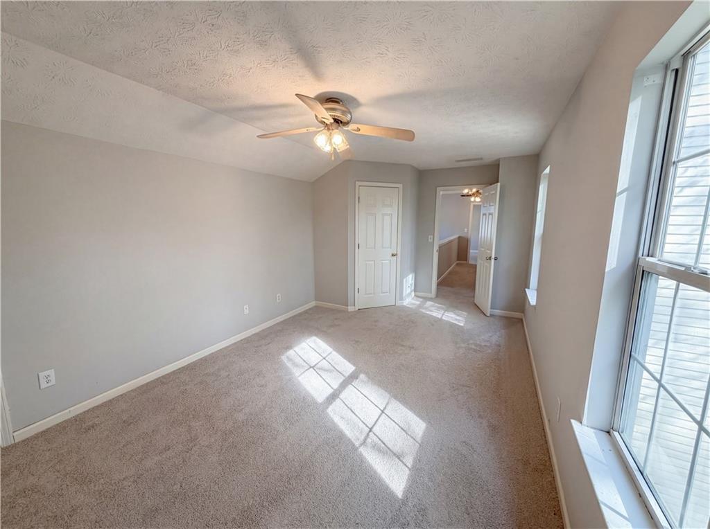 403 Clearstream Lane Austell, GA 30168 - Photo 16 of 25 a view of a big room with chandelier fan and windows