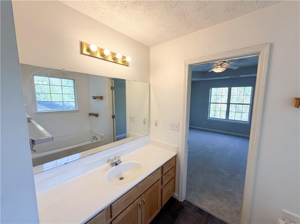 403 Clearstream Lane Austell, GA 30168 - Photo 23 of 25 a spacious bathroom with a bathtub sink and mirror