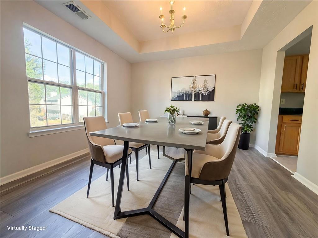 403 Clearstream Lane Austell, GA 30168 - Photo 3 of 25 a dining room with furniture a rug and wooden floor