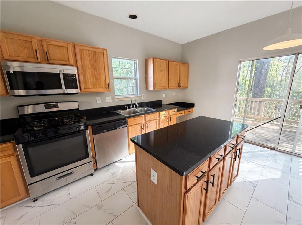 403 Clearstream Lane Austell, GA 30168 - Photo 9 of 25 a kitchen with stainless steel appliances granite countertop a stove a sink and a microwave