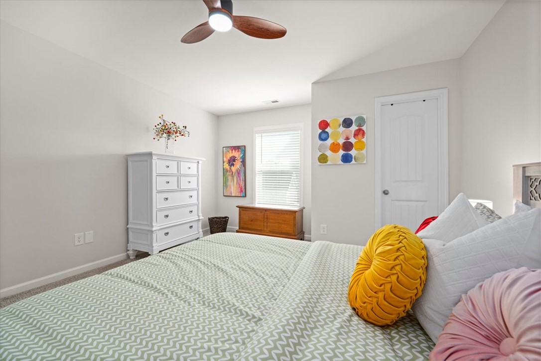 216 Carvel Trail Seneca, SC 29678 - Photo 34 of 46 This cozy bedroom features a sloped ceiling and a window with blinds, creating a bright and inviting atmosphere.