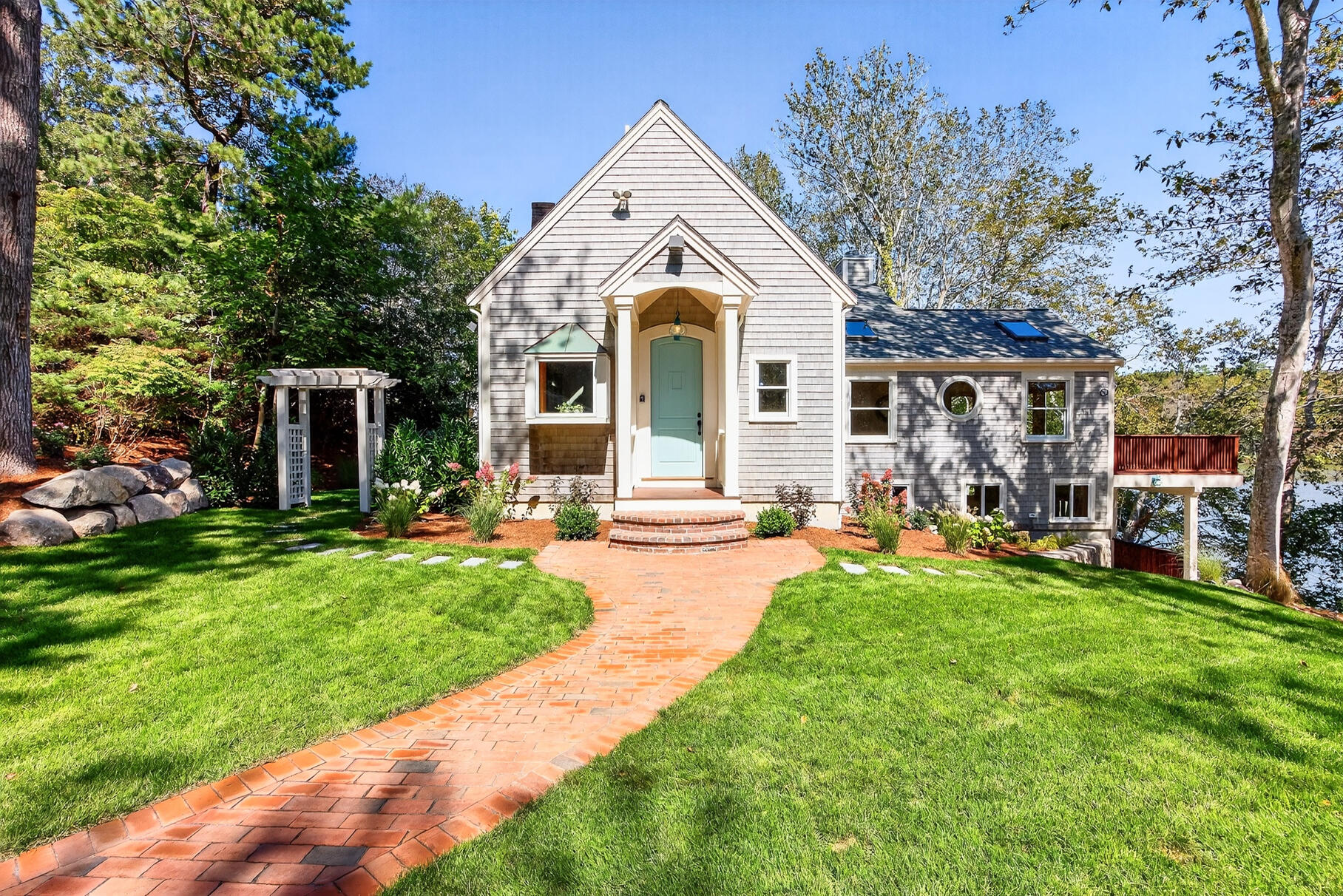 131 Timberlane Drive Mashpee, MA 02649 - Photo 2 of 57 a front view of a house with a garden