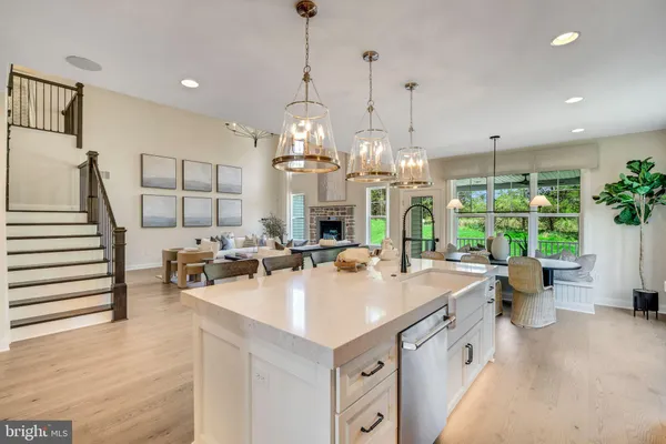 a very nice looking living room with a large dining table and a chandelier