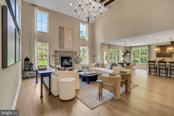a living room with fireplace furniture and a large window
