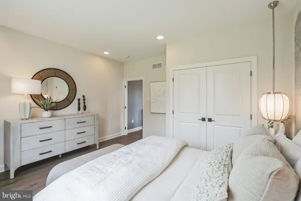 a bedroom with bed and wooden floor