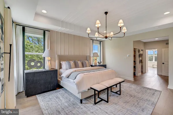 a spacious bedroom with a bed window and a table