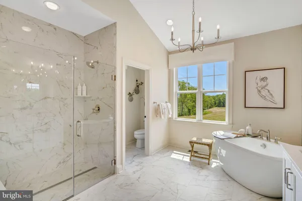 a spacious bathroom with a double vanity sink mirror and bathtub