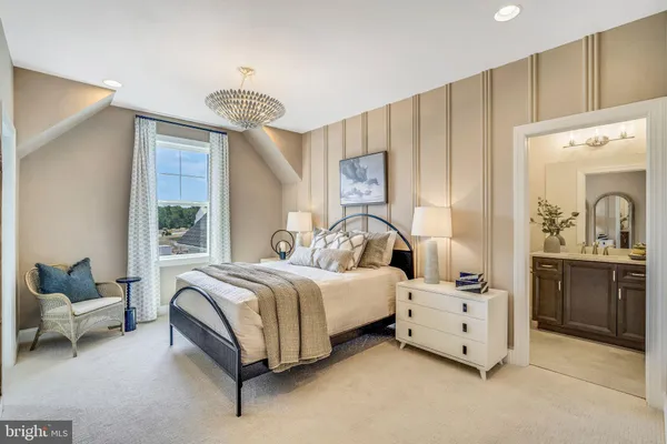 a bedroom with a large bed and a chandelier