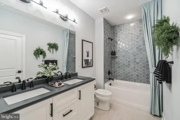 a utility room with sink dryer and washer