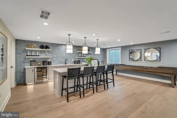 a living room with furniture and kitchen view