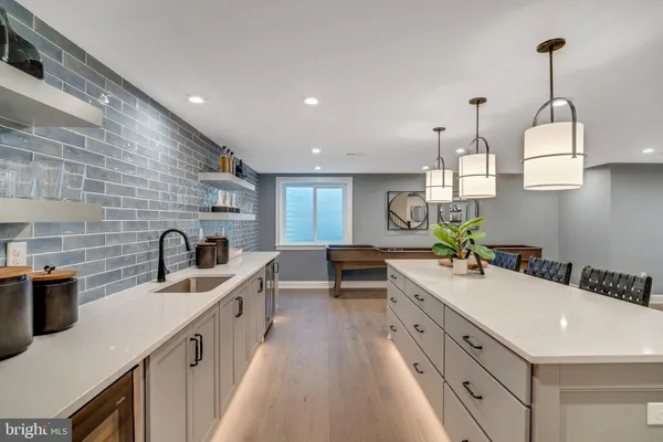 a open kitchen with stainless steel appliances granite countertop a stove top oven a sink counter space and cabinets