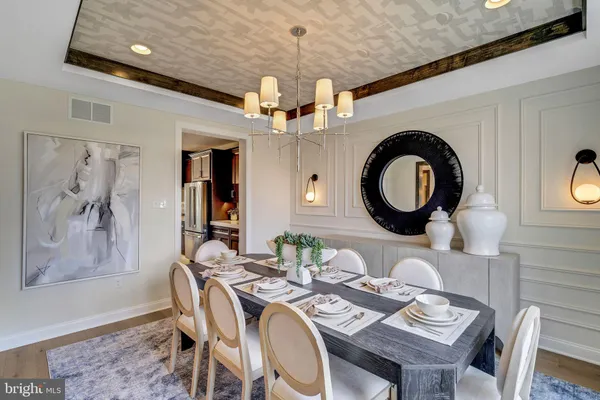 a view of a dining room with furniture and a chandelier
