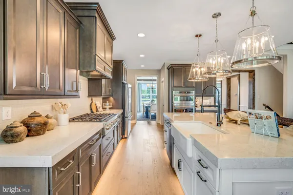 a kitchen with sink stove and cabinets