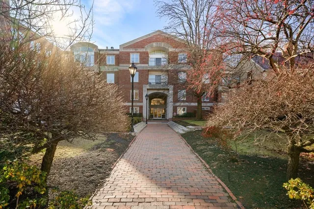 a front view of a house with yard and trees