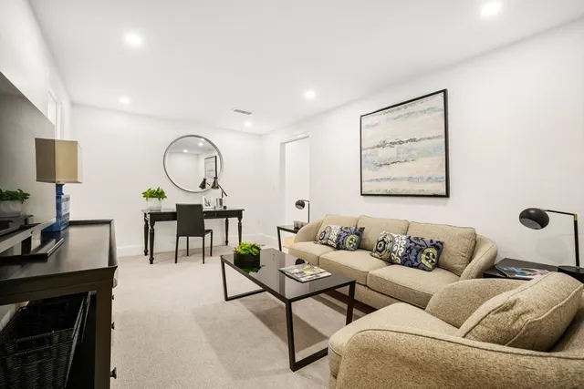 a living room with furniture a fireplace and a flat screen tv