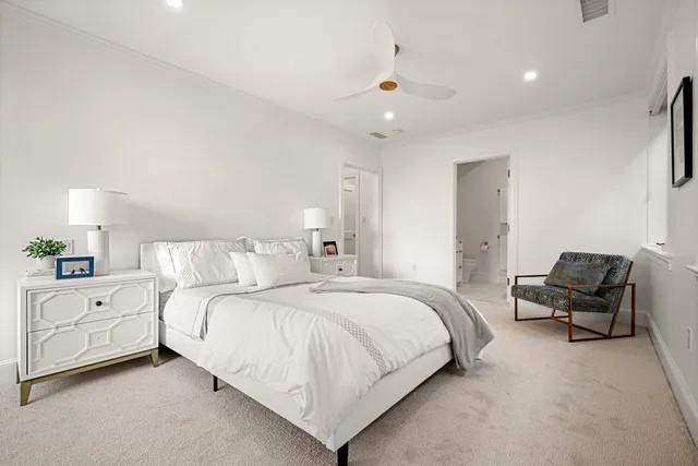 a large bedroom with a bed and a chair