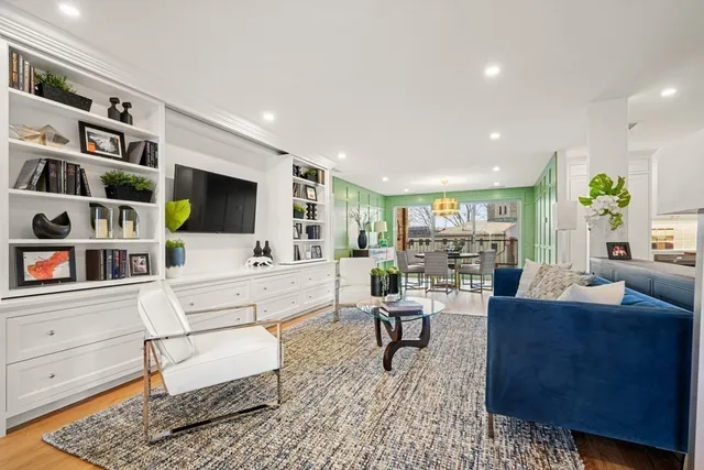 a living room with furniture and a book shelf
