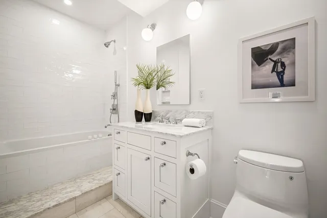 a bathroom with a sink a vanity and a toilet