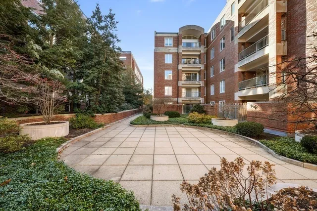 a view of a brick building next to a yard