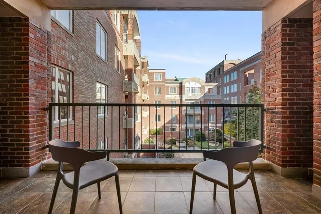 a view of a chairs and table on the balcony