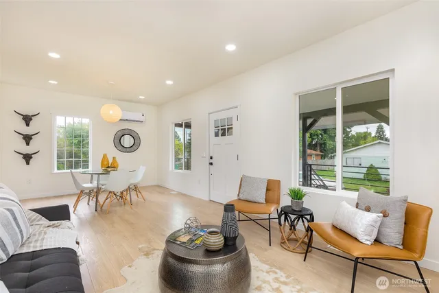 a kitchen with a refrigerator a sink and a stove top oven with wooden floor