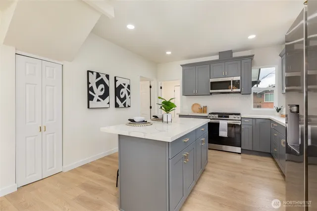 a kitchen with stainless steel appliances granite countertop a sink stove and refrigerator