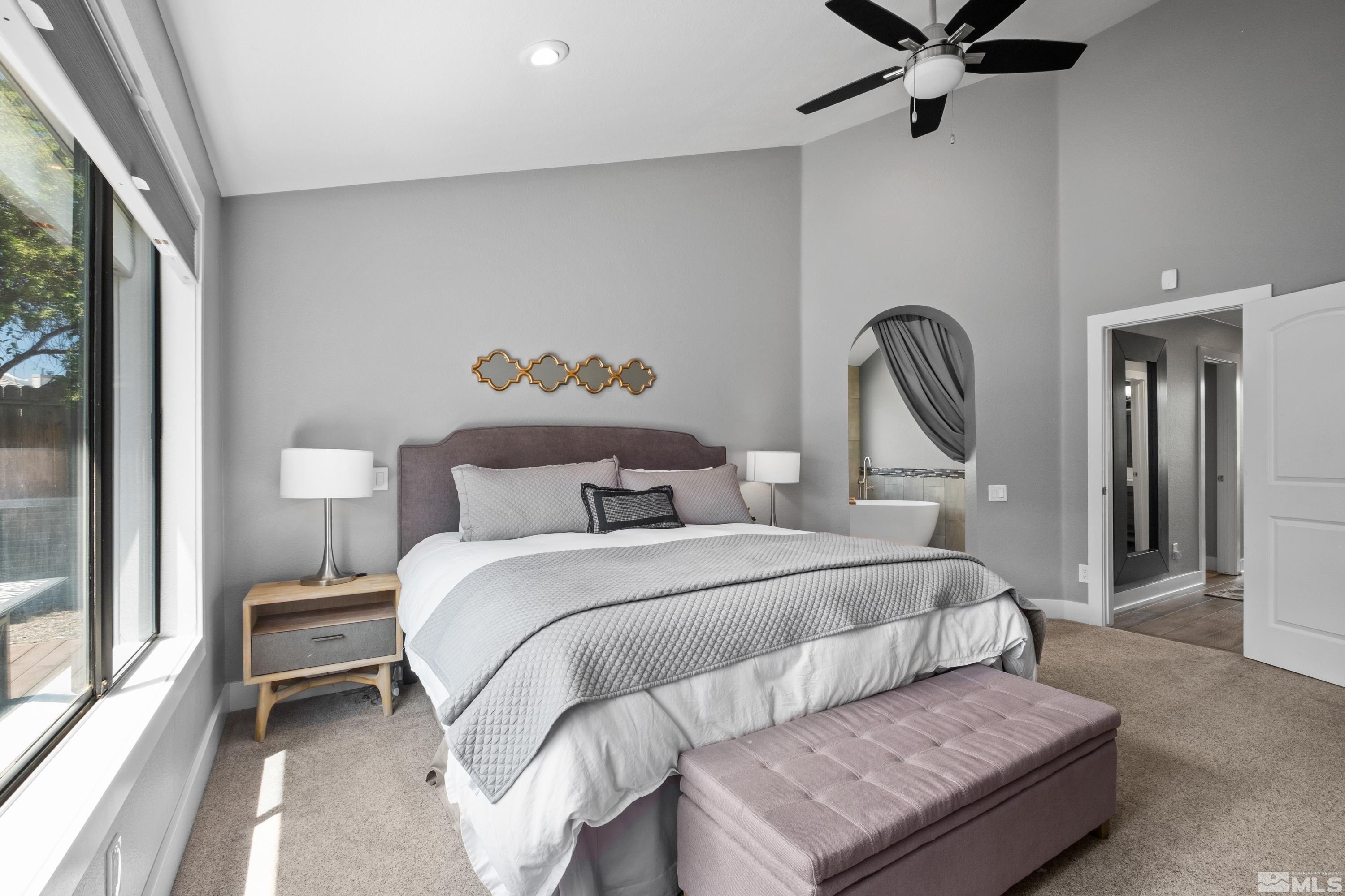 14195 Riata Circle Reno, NV 89521 - Photo 12 of 29 a bedroom with a bed and a chandelier