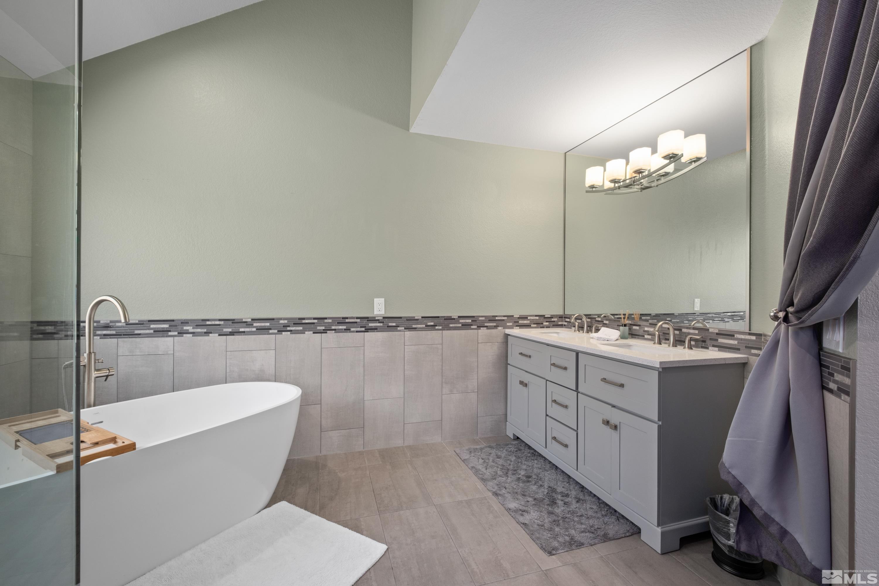 14195 Riata Circle Reno, NV 89521 - Photo 14 of 29 a bathroom with a double vanity sink and a mirror