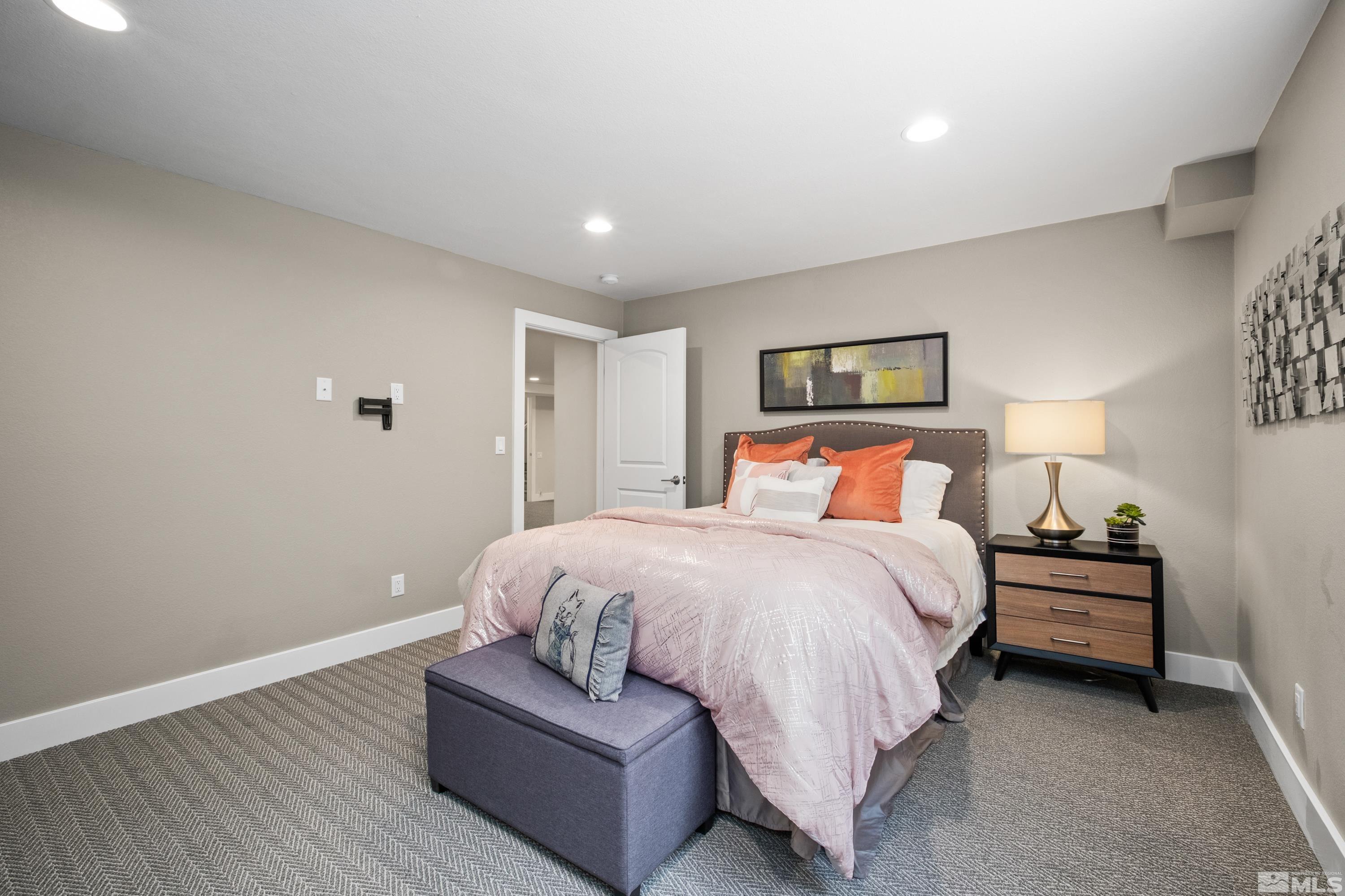 14195 Riata Circle Reno, NV 89521 - Photo 21 of 29 a spacious bedroom with a bed and a couch