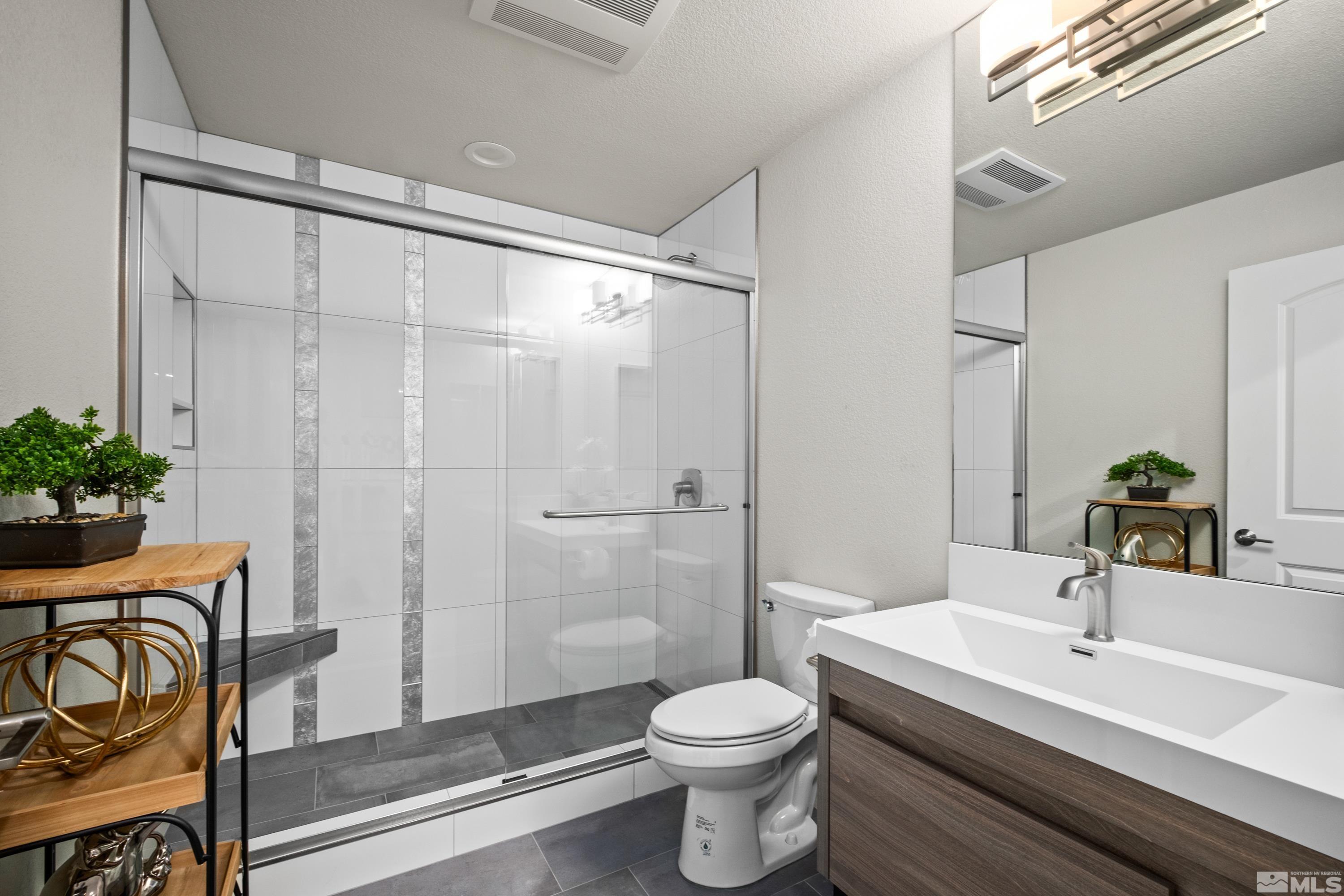 14195 Riata Circle Reno, NV 89521 - Photo 22 of 29 a bathroom with a sink a toilet and shower