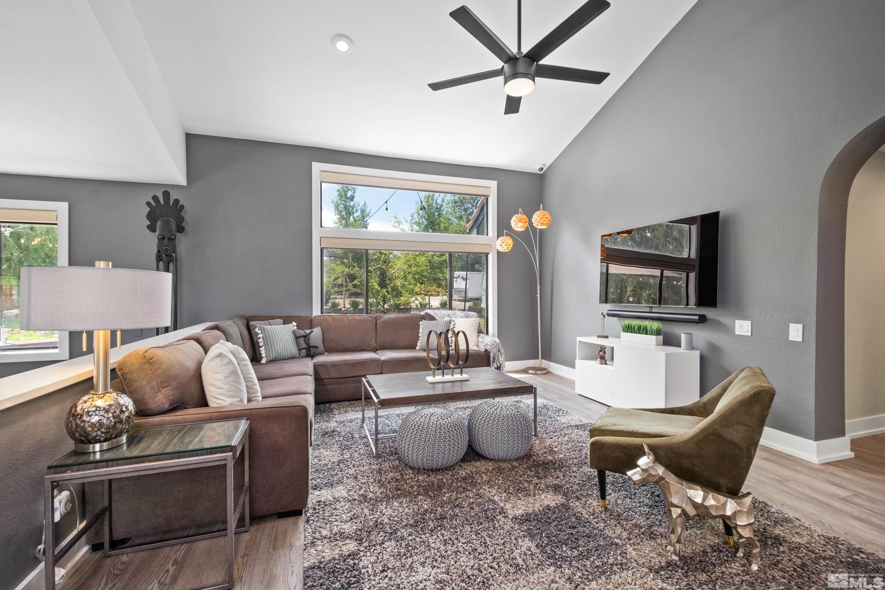 14195 Riata Circle Reno, NV 89521 - Photo 5 of 29 a living room with furniture a flat screen tv and a large window
