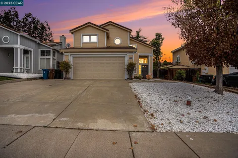 a view of a house with a large space in front of it and covered with trees