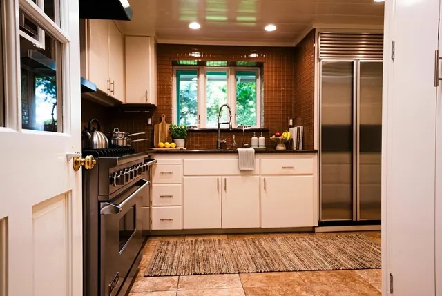 a kitchen with a stove a sink and a refrigerator