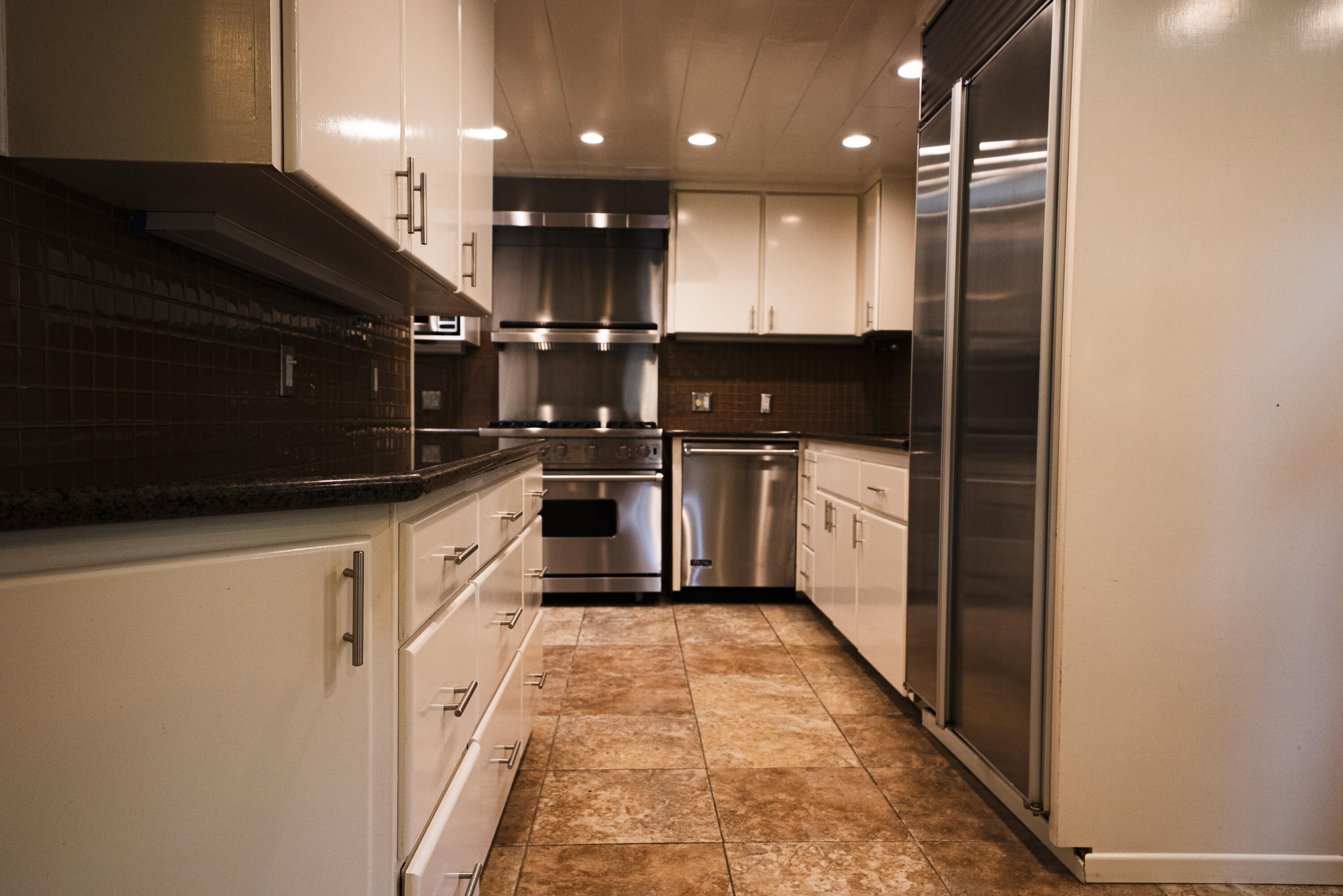 704 Ladera Lane Santa Barbara, CA 93108 - Photo 12 of 20 a large kitchen with stainless steel appliances granite countertop a refrigerator a sink and a stove