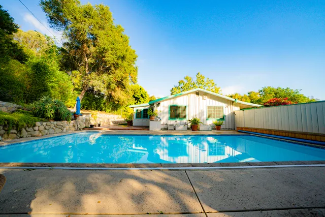a view of a swimming pool with an outdoor space and seating area