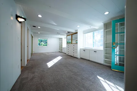 a view of an empty room and a window