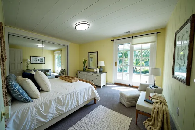 a bedroom with a bed and glass window