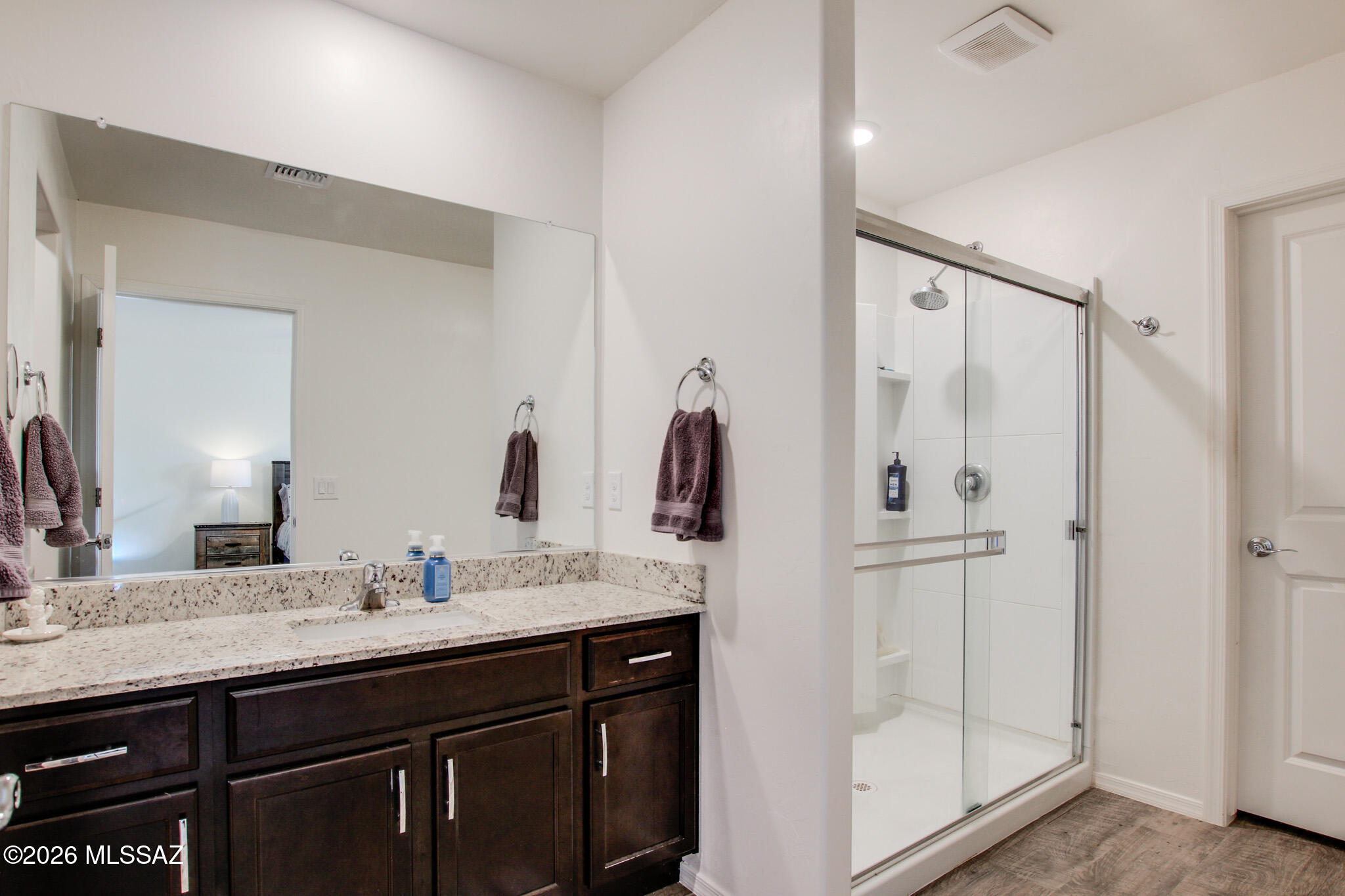7056 South Draper Road Tucson, AZ 85757 - Photo 20 of 22 a bathroom with a double vanity sink mirror and shower