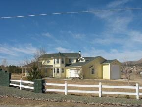 3290 North Reed Road Chino Valley, AZ 86323 - Photo 3 of 8 a front view of a house with a yard