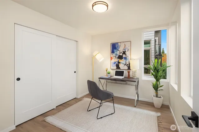 a view of a workspace with furniture and a potted plant