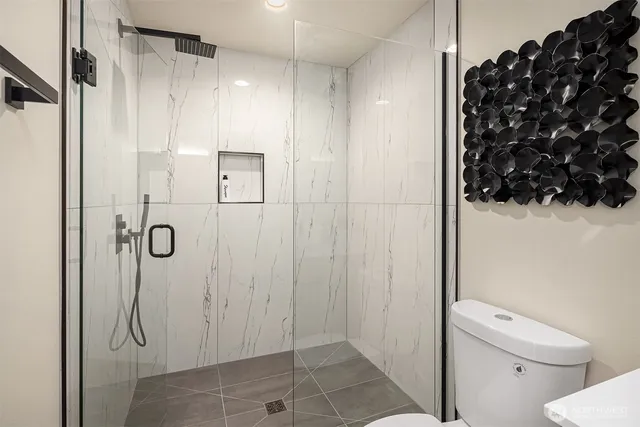 a bathroom with a shower and a toilet